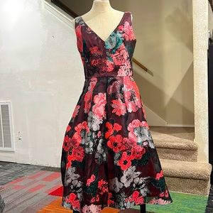 MIDI length dress brand Lela Rose colors pink/green, black, and silver